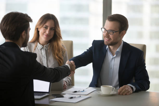 Millennial business partners shaking hands greeting ready to negotiate, company CEO handshaking colleague after successful meeting or negotiations in office. Concept of partnership, cooperation